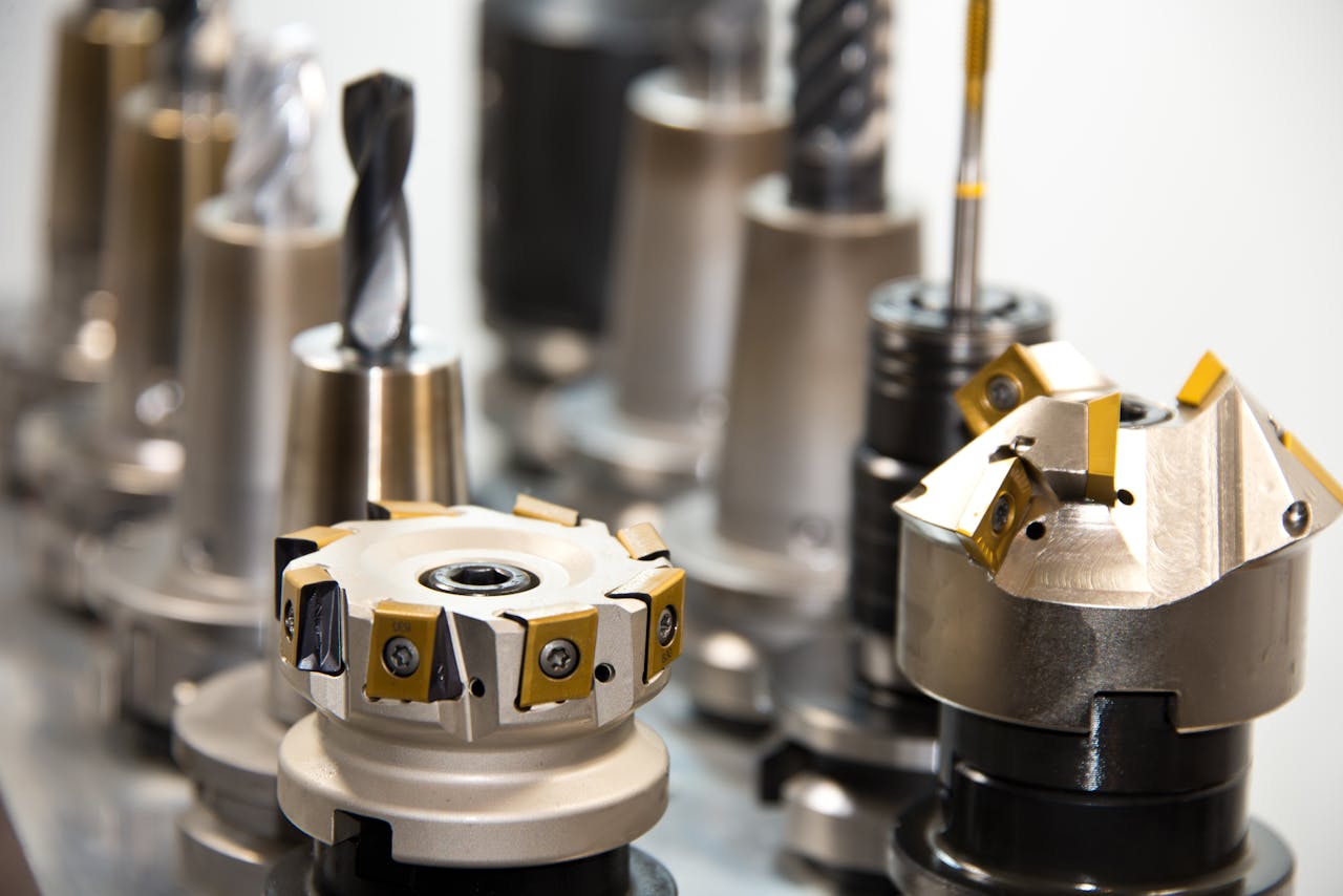 gallery-3 Detailed view of various metal drill bits and tools arranged in a workshop setting.