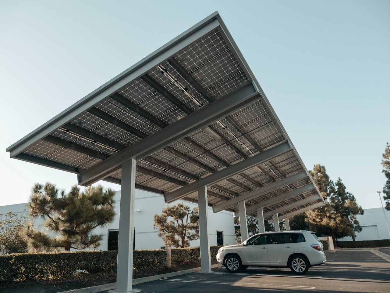 services-01 Solar panel carport in a modern urban setting, showcasing clean energy solutions.